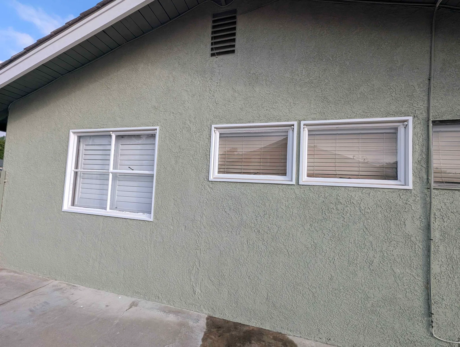 Side windows with white frames and shutters after cleaning